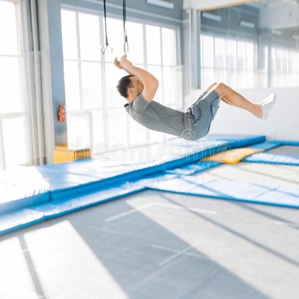 sportieve mens die omhoog en dowwn op de trampoline springen 134495521